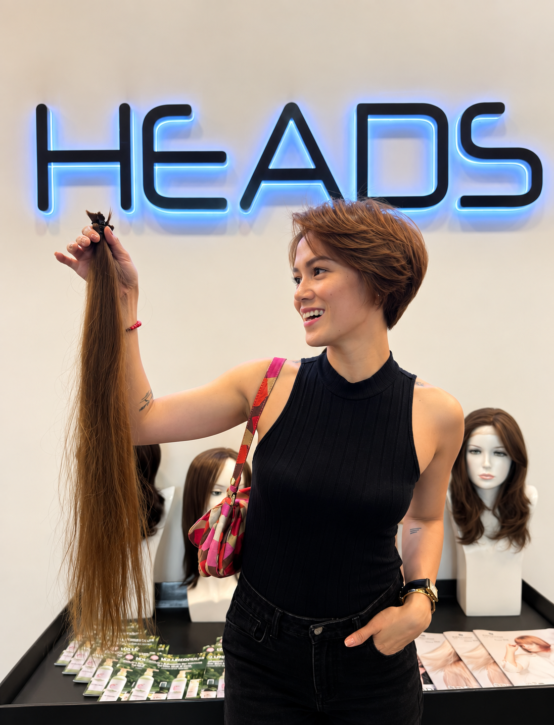 A HEADS donor holding the hair she is giving to Hair for Hope